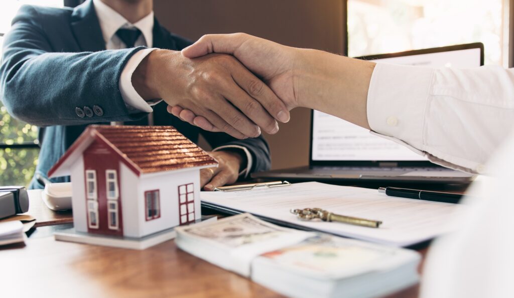 Home Sales Agents And Buyers Work On Signing New Homes And Shaking Hands